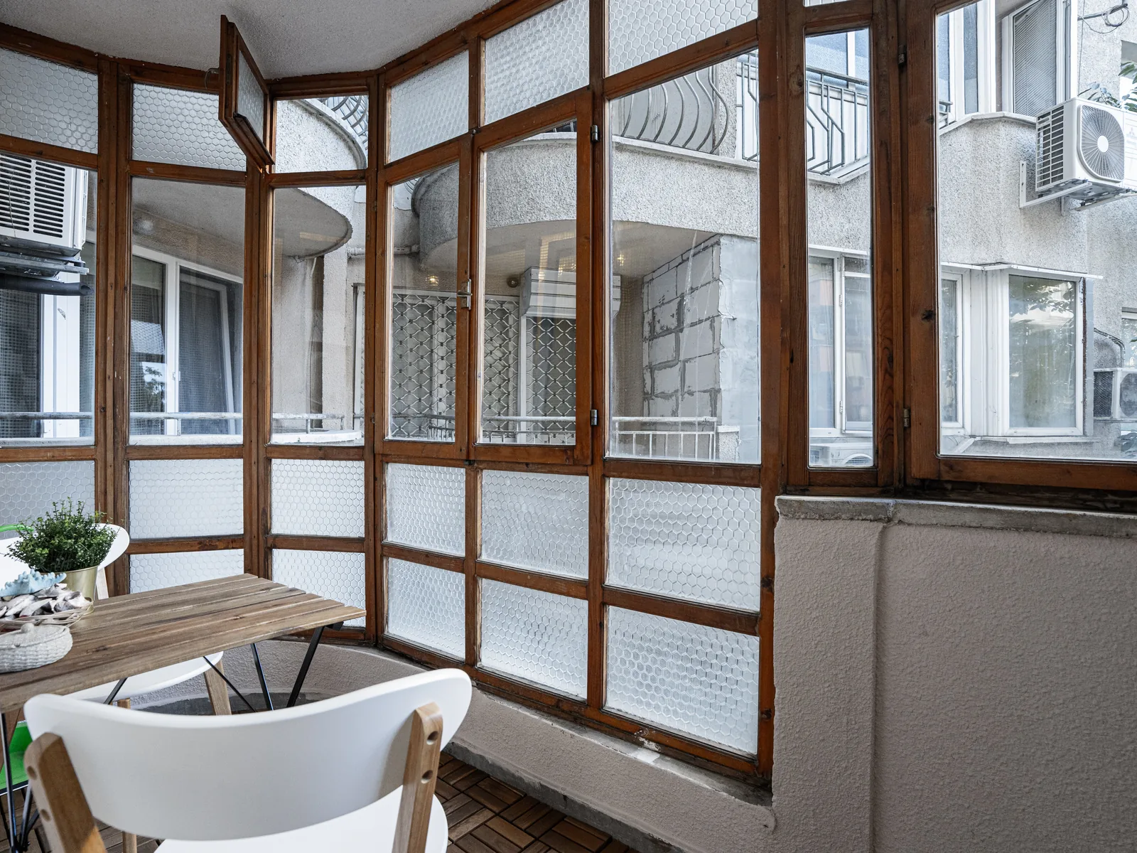 Enclosed balcony with a small table for two