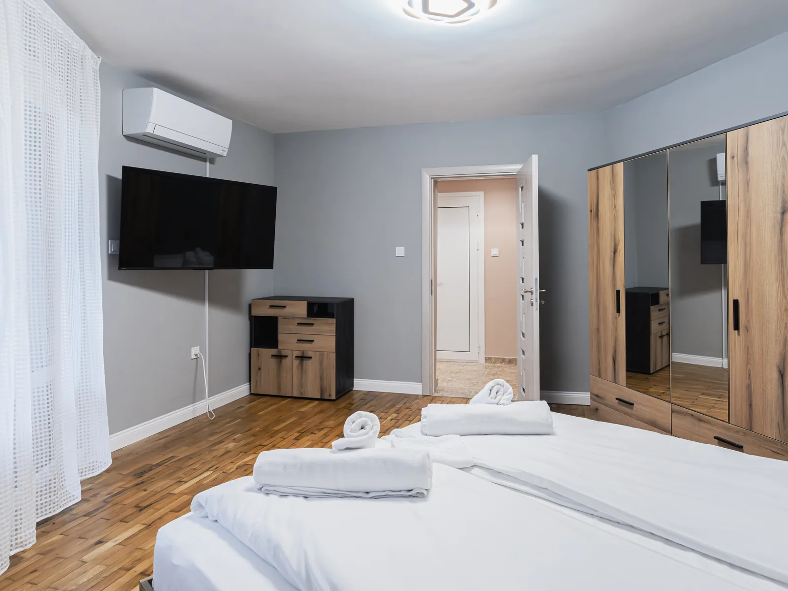 Bedroom 1 with TV, air conditioning and wardrobe